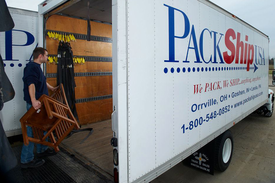 Man Loading Package into PackShip Truck